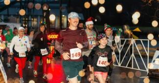 Runners in holiday gear run a race