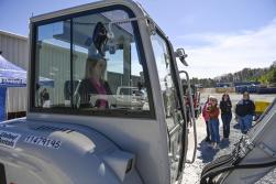 Peyton Hogan sits in a mini excavator during the equipment rodeo, sponsored by United Rentals. Photo by Paige Dingler.