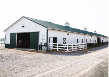 White Stable Building with Green roof and doors at Liberty Mountain Equestrian Center