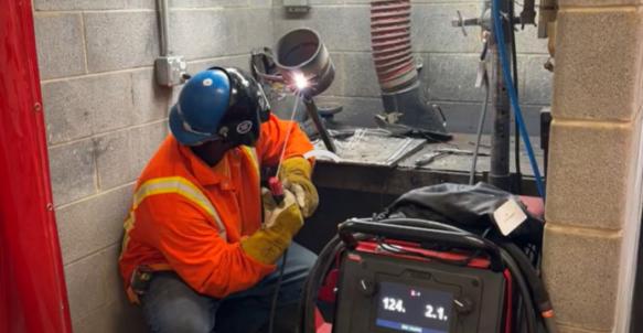 Welder welds a seam during welding competition.