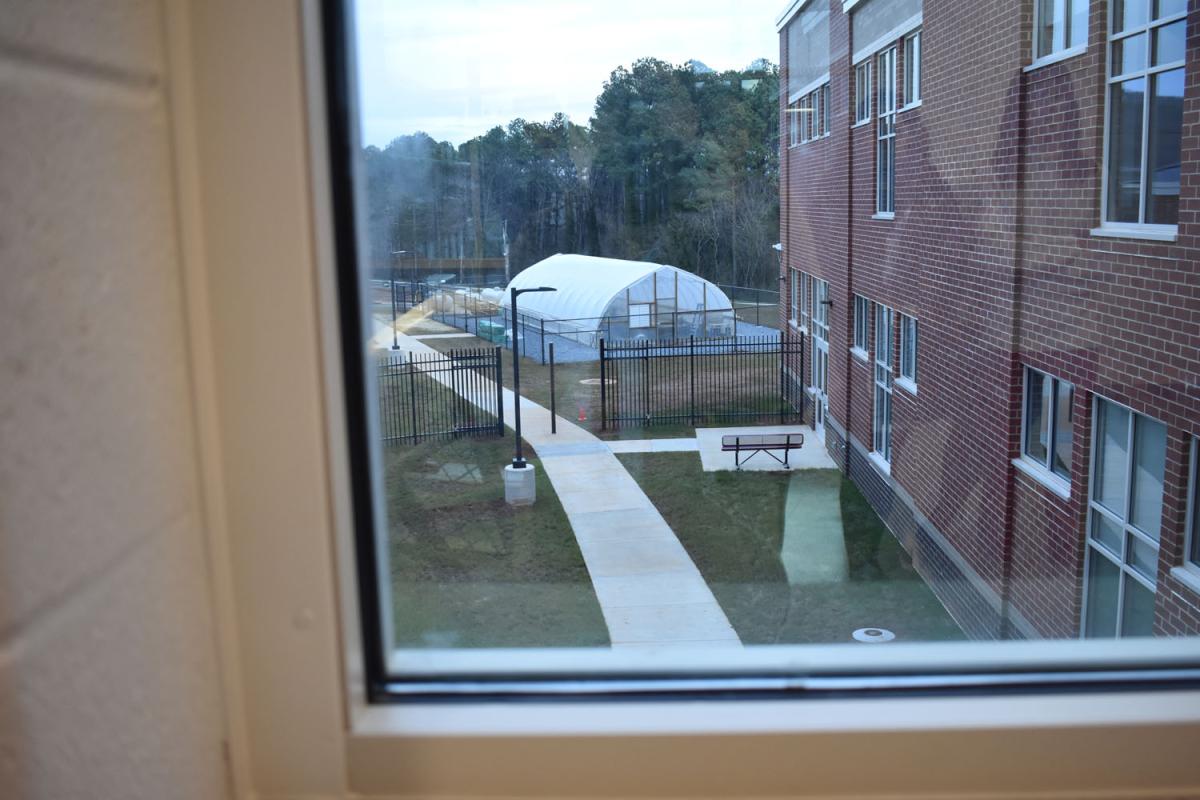 Greenhouse in the distance beyond school courtyard