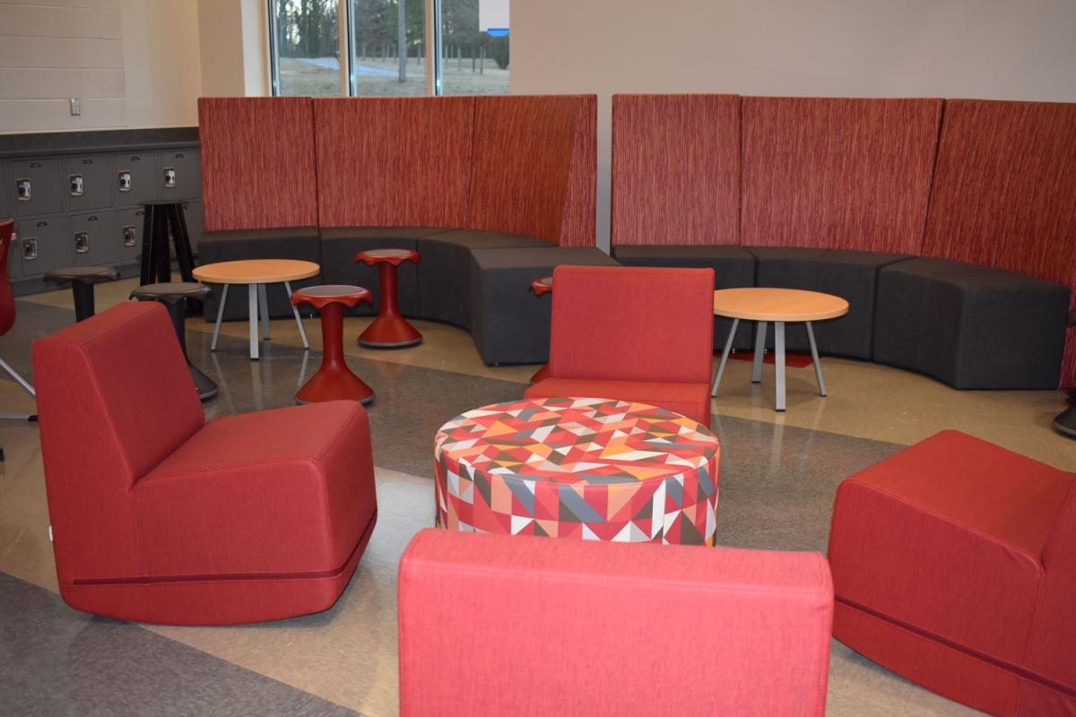 Soft chairs and a wall of bench seating in bright colors