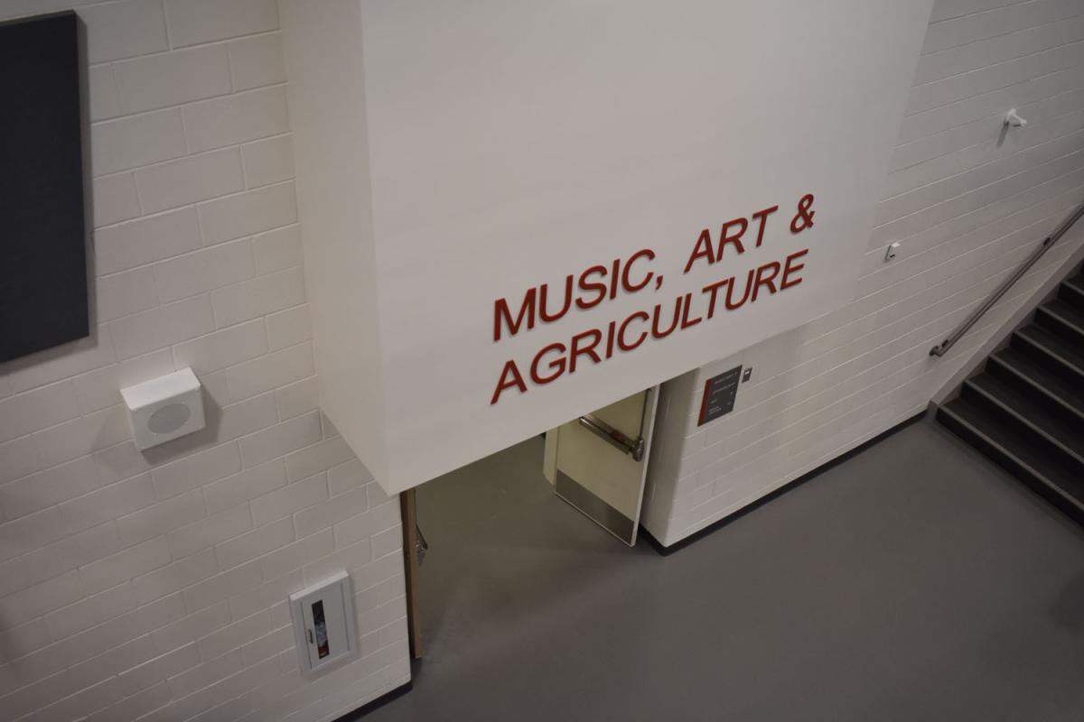 Entrance with sign that reads "music, art and agriculture"