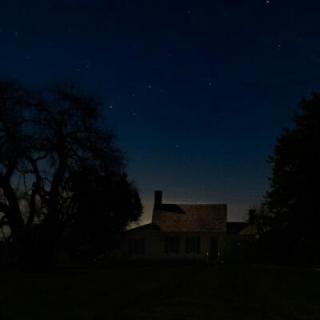 Night photo of Red Hill's main house.